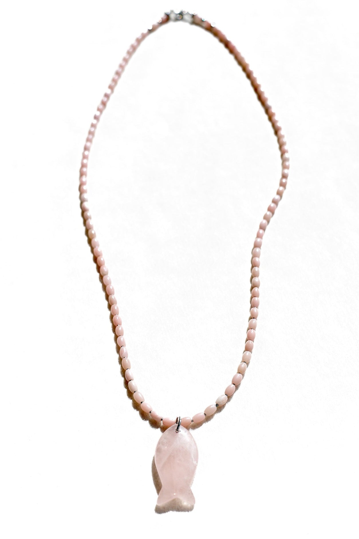 Necklace with pink beads and a fish-shaped pendant on a white background