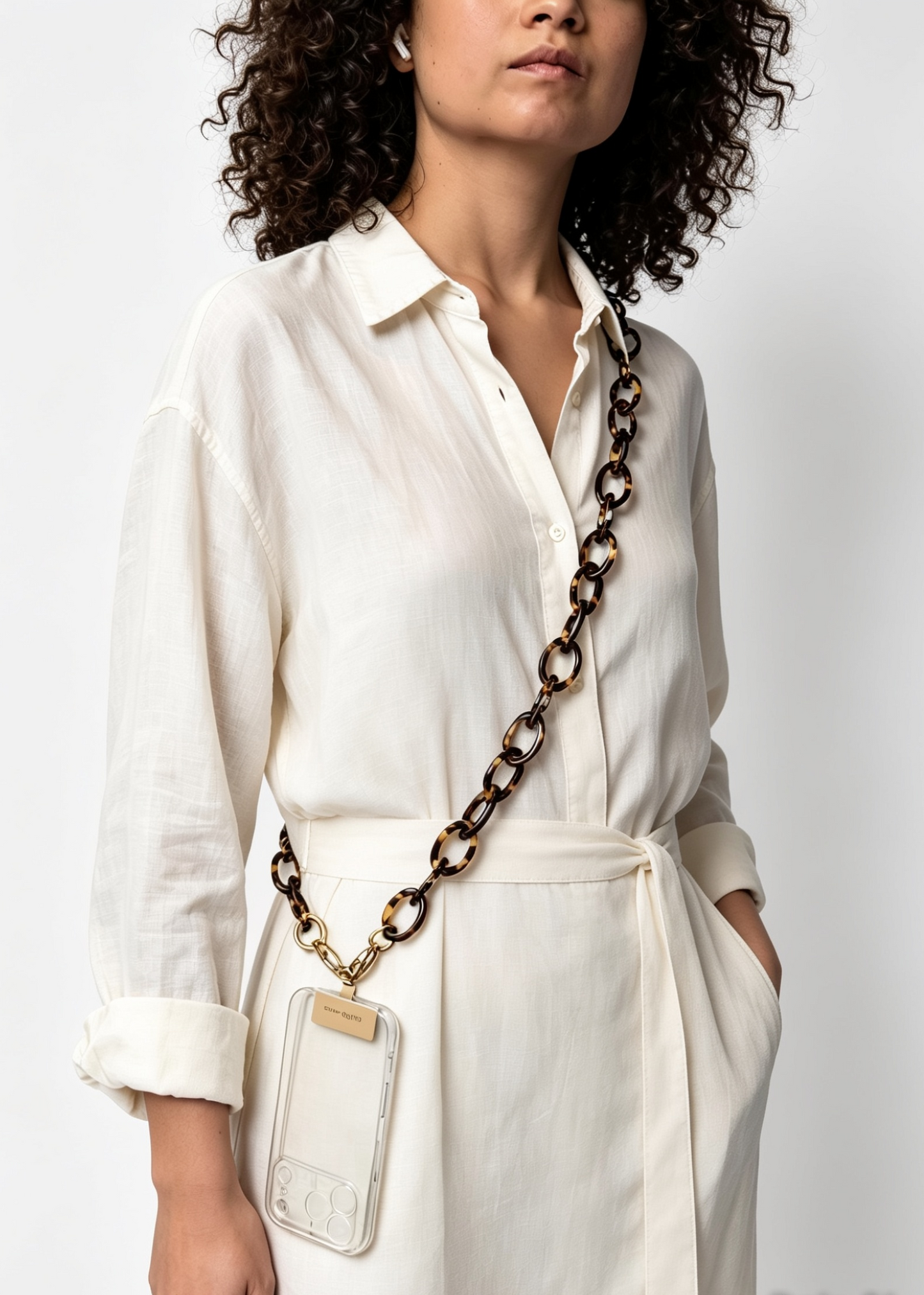 Woman wearing a white shirt with a long brown tortoiseshell bio acetate phone chain

