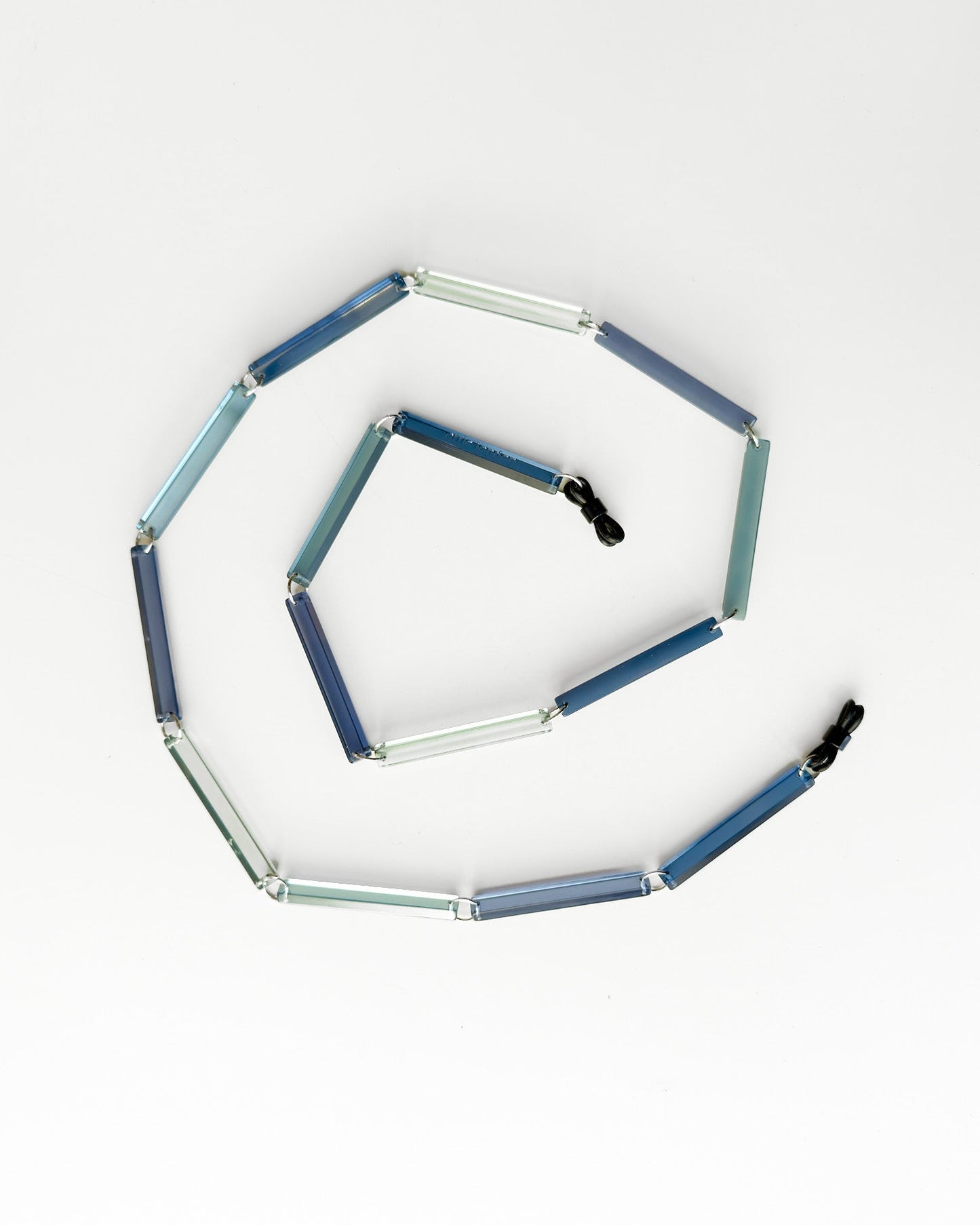 Hexagonal modular toy with blue and clear segments on a white background glasses chain